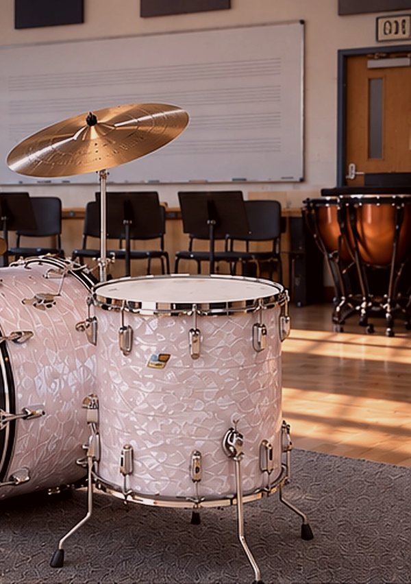 White marine pearl floor tom with timpani behind it