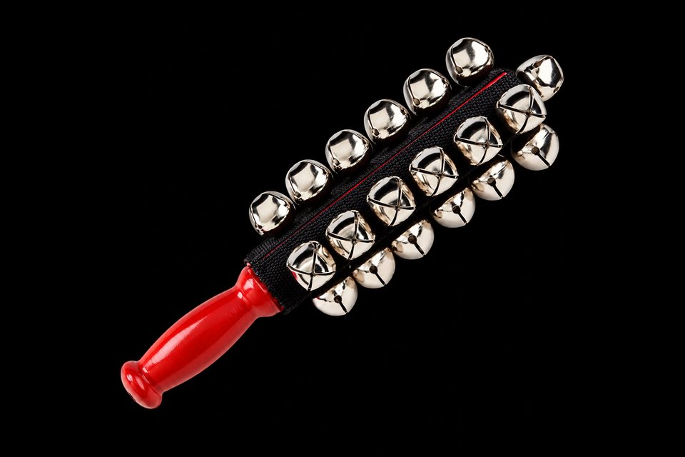 Sleigh bells: rows of silver jingle bells on a strap with a red wooden handle