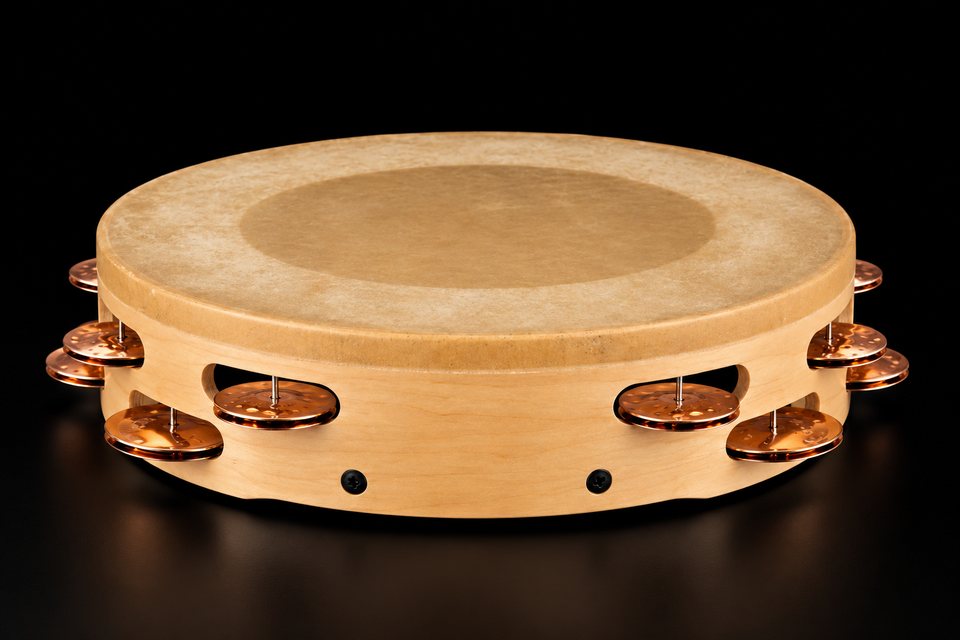 A wood tambourine with a natural skin head and copper jingles