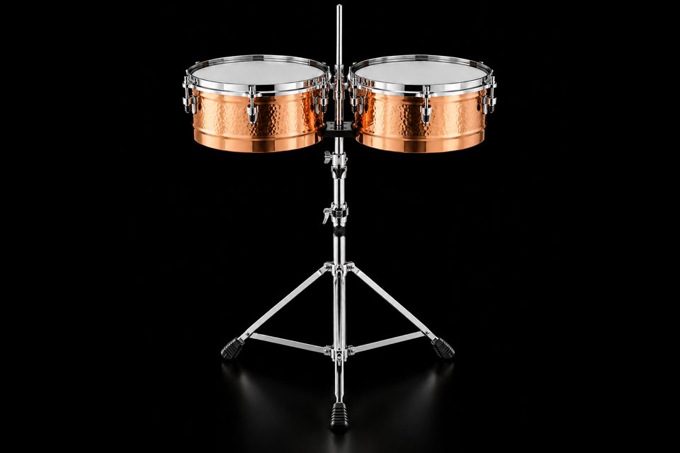 A pair of hammered copper timbales on a chrome stand